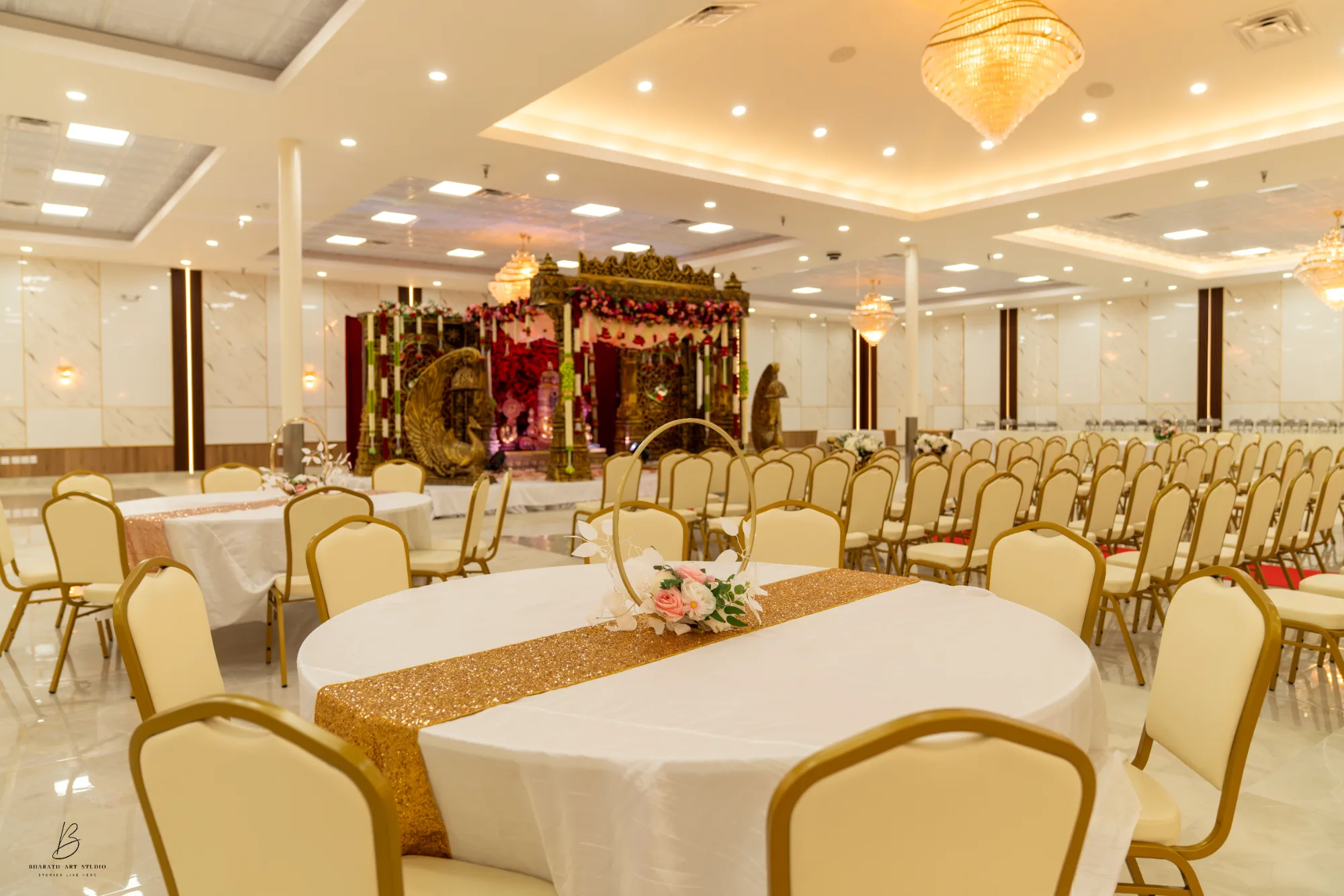 Peacock-carved mandap with theatre-style ceremony seating at Triveni Banquet, Northern Virginia